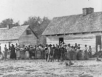 Slaves standing in front of buildings on Smith's Plantation, Beaufort, South Carolina